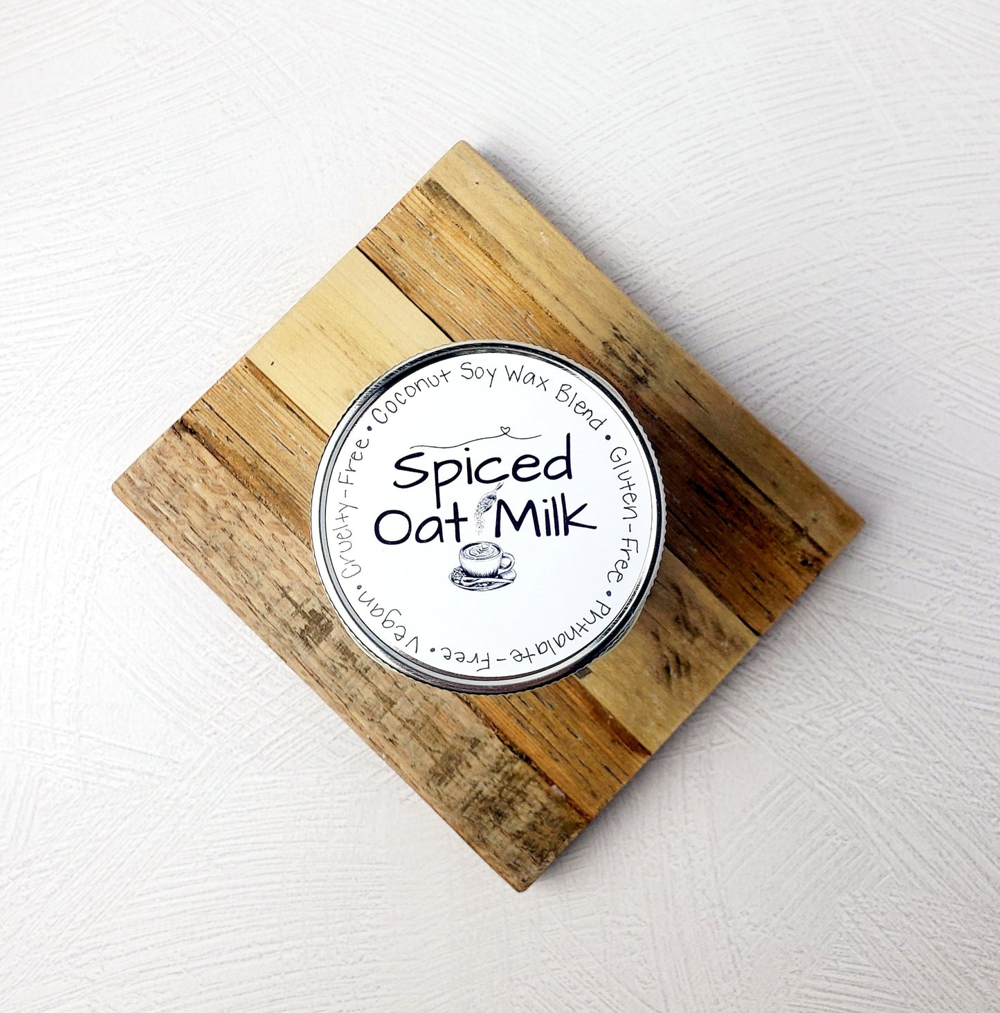 View of Spiced Oat Milk candle lid on wooden trivet.