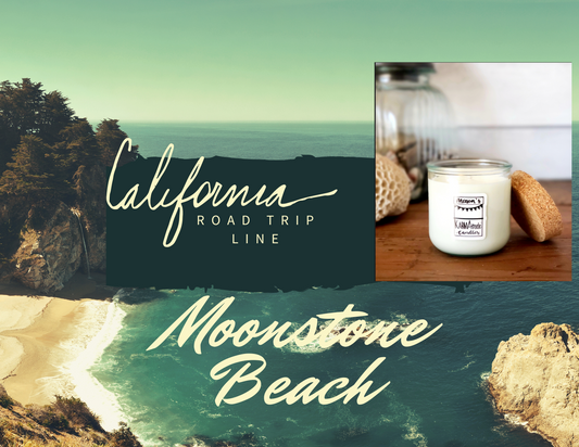 Photo of Moonstone Beach Karmatude candle in clear glass jar with cork lid surrounded by ocean and trees.